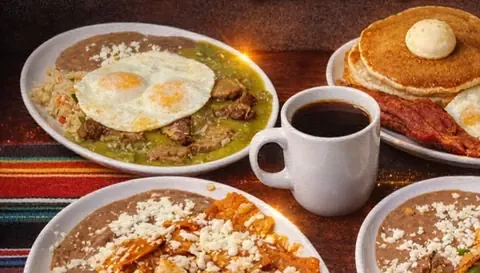 Mexican breakfast plates with eggs, chilaquiles, pancakes and coffee at Camacho's Restaurant