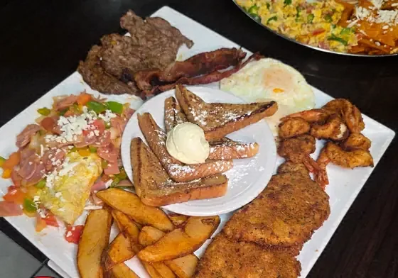 Charola Gabacha breakfast plate with French toast, omelet, shrimp, chuletas and home fries at Camacho's Restaurant