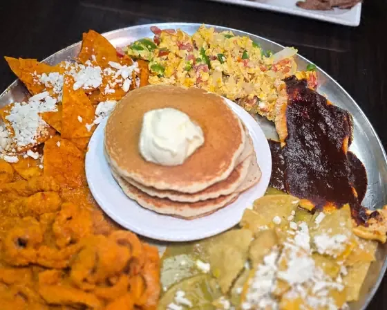 Charola Mexicana breakfast tray with pancakes, chilaquiles, chicharrón and mole at Camacho's Restaurant