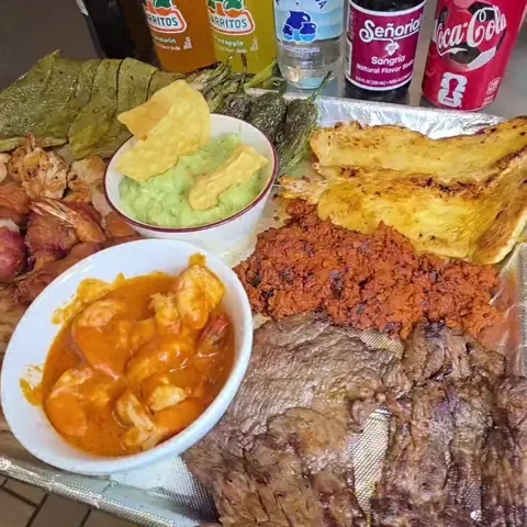 Grilled meats tray with guacamole and Mexican sodas at Camacho's Restaurant